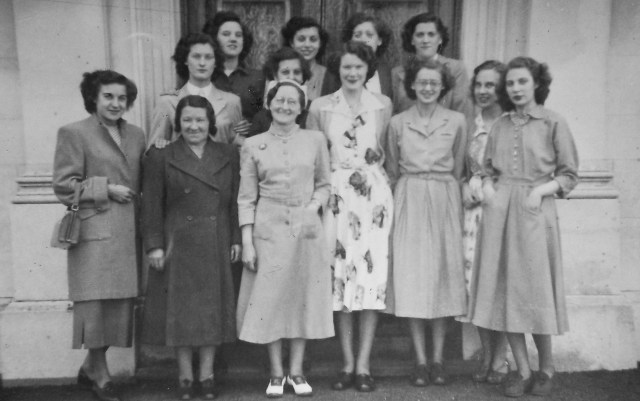 The staff of the Walsall branch of Dorothy Perkins in the early 1950s.  A young Irene Sheldon, second row, left, has one hand on the shoulder of Mrs. Rathbone, the cleaner.  Mrs. Brown, manageress, is at the front.